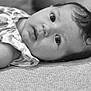 Mila joined the competition — help win amazing prizes! baby, infant, face, eyes, curious, close_up, black_and_white, portrait, child, lying_down, soft_lighting, expression, texture, fabric, clothing, person, head, skin, young, indoors