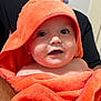 Emilio joined the competition — help win amazing prizes! baby, infant, towel, orange, hood, cute, face, eyes, expression, skin, person, child, wrapped, cloth, indoor, adult, holding, portrait, closeup, smile