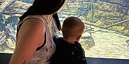 Emilio joined the competition — help win amazing prizes! person, baby, tattoo, aquarium, fish, rock, water, indoor, dark, light, child, holding, back, sitting, viewing, nature, tank, animal, parent, adult