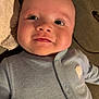 Emilio is registered to the contest to win money with this photo: baby, infant, face, smile, onesie, blue_clothing, closeup, child, plush_toy, soft_texture, cute, happy, indoors, head, person, newborn, skin, eyes, cheeks, lying_down