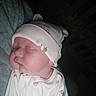 Lilly is registered to the contest to win money with this photo: baby, sleeping, hat, onesie, infant, child, face, headwear, closeup, soft, cozy, cute, newborn, patterned_clothing, person, rest, peaceful, indoors, portrait, sleep