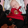 Lilly is registered to the contest to win money with this photo: baby, sleeping, car_seat, headband, bow, red_clothing, reindeer_patch, knitted_booties, cozy, child, infant, cute, peaceful, soft_cushion, straps, black_pants, closeup, indoors, adorable, resting