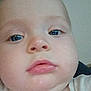 Colt joined the competition — help win amazing prizes! baby, child, face, closeup, blue_eyes, chubby_cheeks, skin, infant, portrait, expressionless, young, person, head, nose, lips, eyebrows, clothing, white_shirt, indoors, natural_light