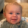baby, smiling, face, blue_eyes, sweater, infant, child, cute, happy, portrait, seat, indoor, cozy, young, cheerful, closeup, skin, head, expression, person