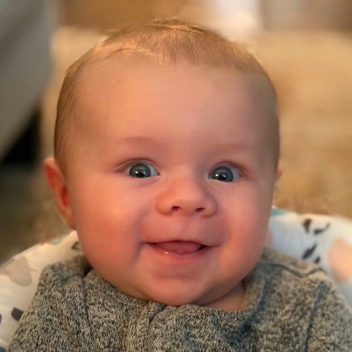 Stetson is registered to the contest to win money with this photo: baby, smiling, face, blue_eyes, sweater, infant, child, cute, happy, portrait, seat, indoor, cozy, young, cheerful, closeup, skin, head, expression, person