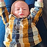 éliot a rejoint le concours — aidez-le/la à gagner de superbes lots ! baby, child, plaid_shirt, tan_pants, blue_jeans, person, arms_up, lying_down, indoor, legs, casual_clothing, expression, stretching, infant, cute, human, portrait, young_child, relaxed, small