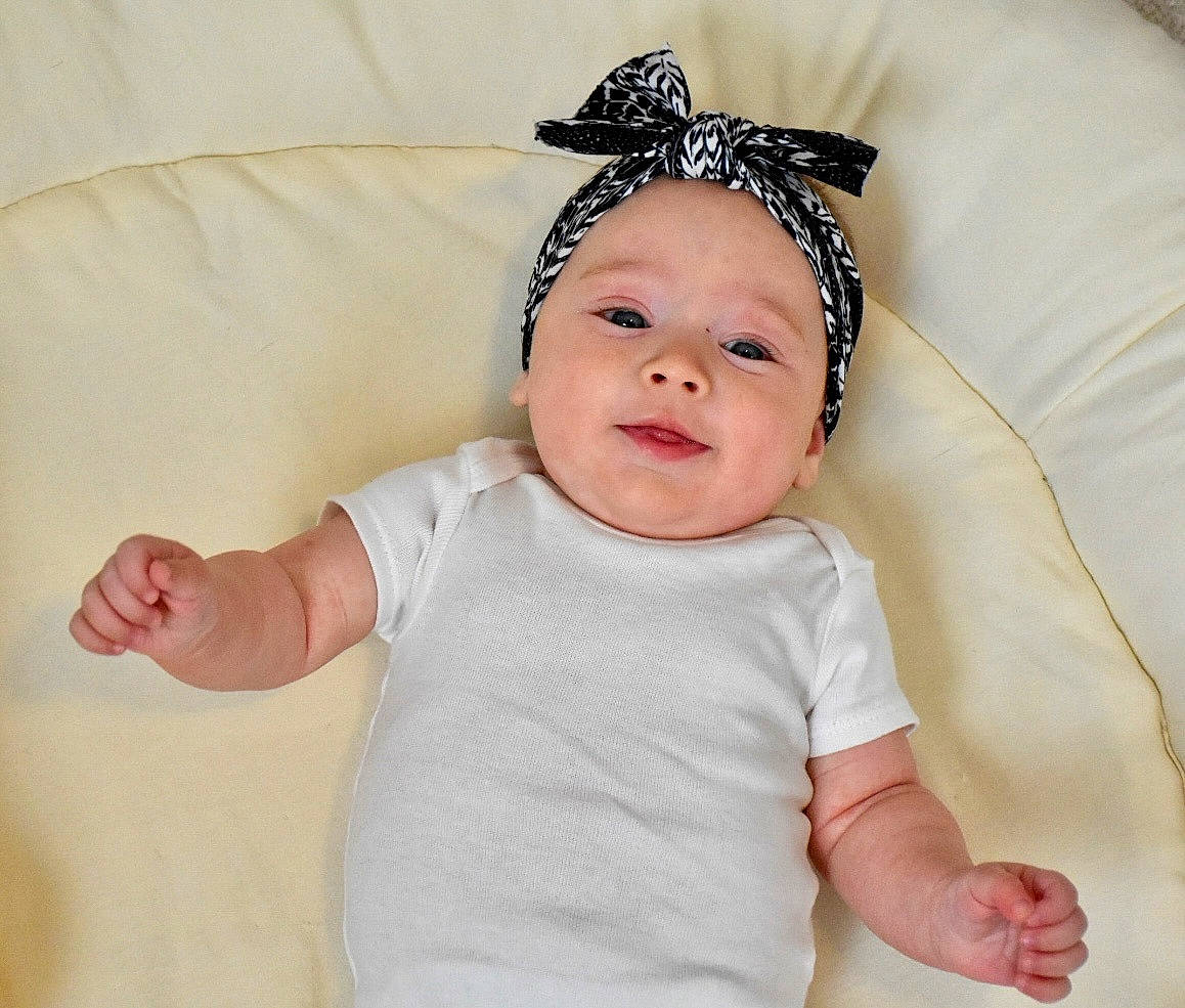 Lainey is registered to the contest to win money with this photo: baby, baby_sleeping, baby_toddler_clothing, child, comfort, costume_hat, eye, face, fashion_accessory, gesture, happy, head, headband, headpiece, linens, person, product, sleeve, smile, textile