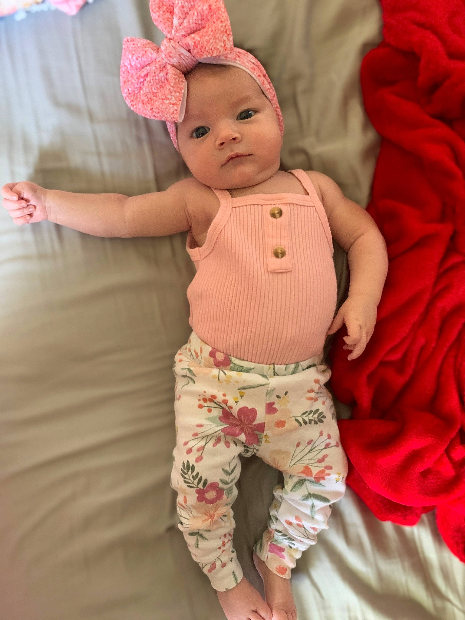 Brylee is registered to the contest to win money with this photo: abdomen, baby, baby_products, baby_toddler_clothing, cap, cheek, child, fashion_accessory, fun, happy, headband, linens, magenta, pattern, peach, person, pink, skin, sleeve, textile