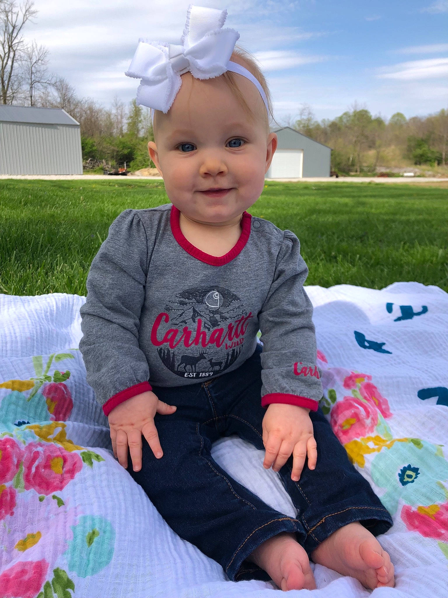 Maisy is registered to the contest to win money with this photo: baby, baby_toddler_clothing, child, cloud, face, fun, grass, green, happy, head, joy, person, pink, plant, skin, sky, sleeve, smile, t_shirt, toddler