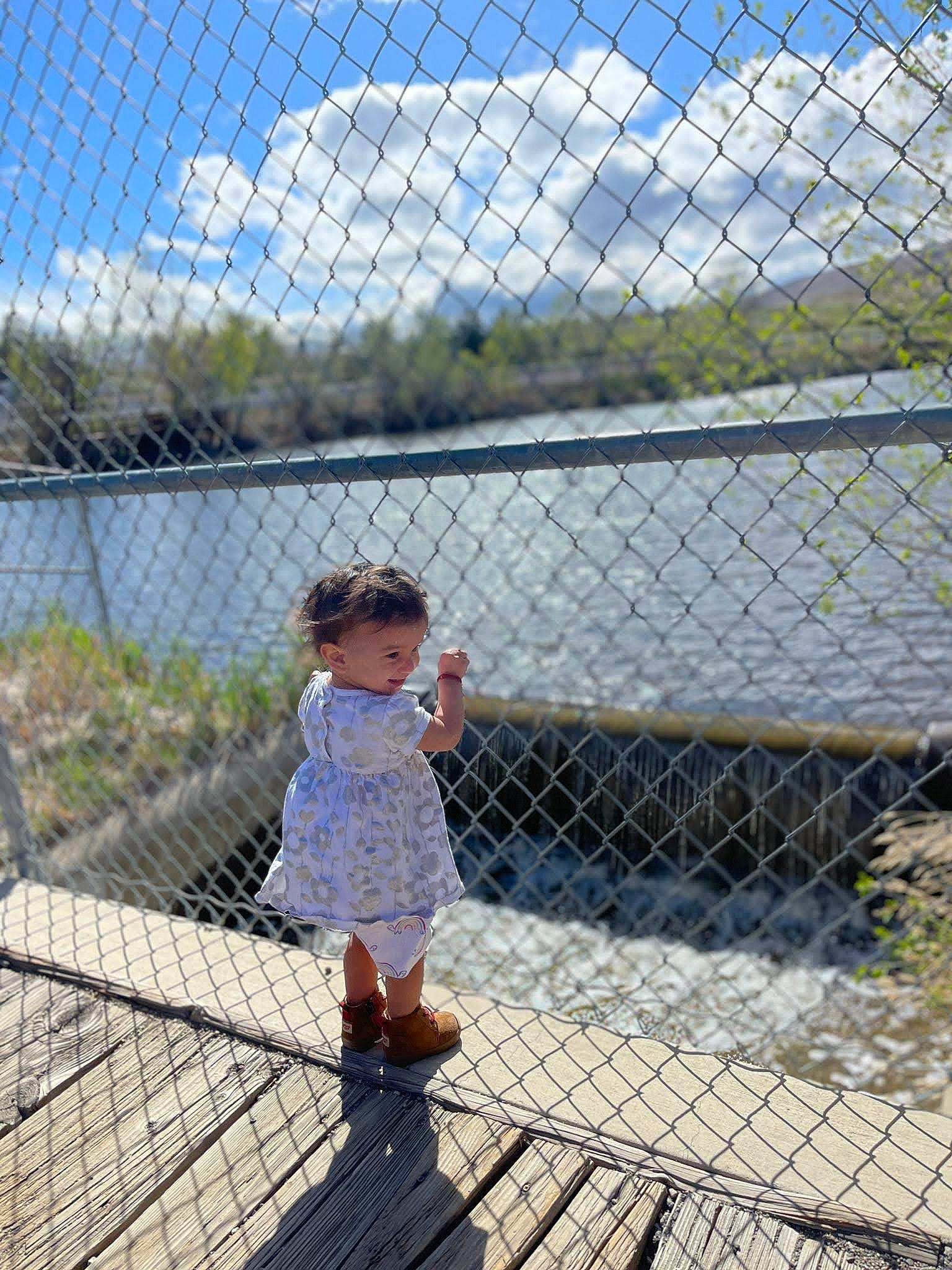 Emma joined the competition — help win amazing prizes! chain_link_fencing, child, cloud, composite_material, fence, fun, grass, leisure, line, mesh, metal, pattern, person, plant, recreation, sky, toddler, tree, water, wire_fencing
