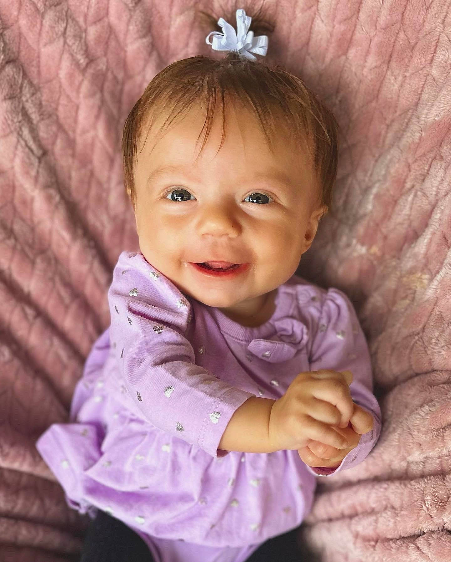 Fallon joined the competition — help win amazing prizes! baby, baby_toddler_clothing, cheek, chin, eye, face, gesture, hair, happy, head, iris, organ, person, pink, product, purple, skin, sleeve, smile, textile
