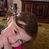 carpet, child, cute, face, furniture, girl, hair, happy, home, indoors, living_room, person, pigtails, pink_dress, playful, portrait, smiling, tv, wooden_cabinet, young