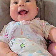 Willow is registered to the contest to win money with this photo: baby, smiling, infant, blanket, cushioned_seat, happy, face, child, clothing, indoor, cute, person, portrait, playful, colorful, cozy, young, expression, wrapped, joyful