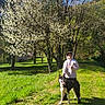 blossom, blue_sky, canine, dog, field, flower, grass, greenery, happy, hoodie, nature, outdoor, park, person, shadow, smile, spring, sunlight, thumbsup, tree