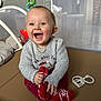 Timéo participe au concours pour gagner de l'argent avec cette photo : baby, smiling, sweater, red_pants, sock, toy, teether, play_mat, indoor, child, happy, cute, infant, clothing, person, seat, home, fun, cheerful, playtime