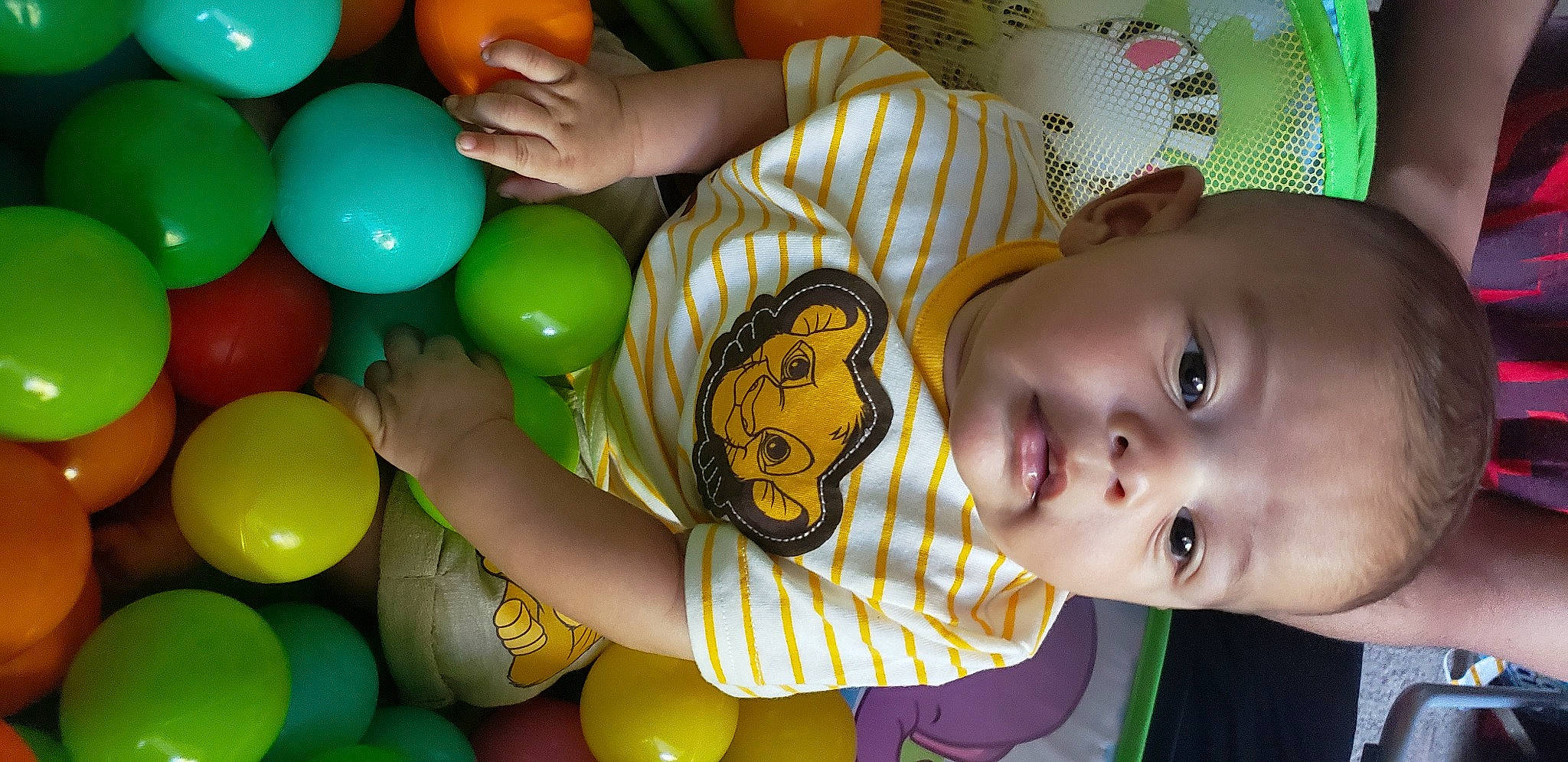 Keanu is registered to the contest to win money with this photo: baby, baby_toys, balloon, child, fun, green, happy, party, party_supply, person, play, room, smile, toddler, toy, yellow