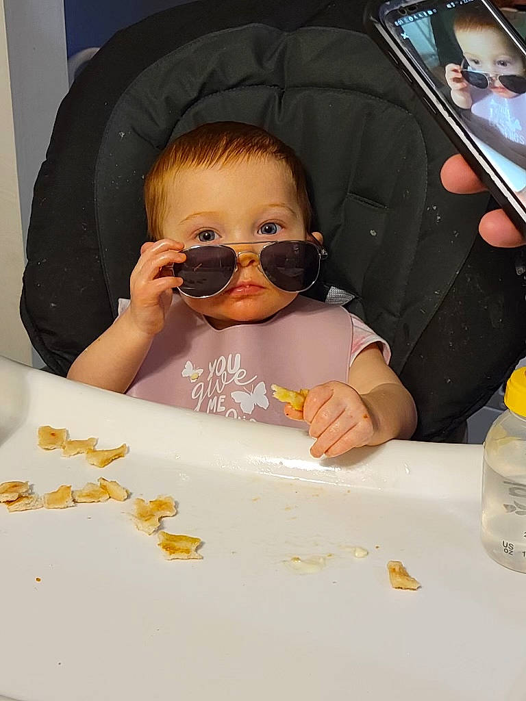 Scarlet Rose is registered to the contest to win money with this photo: baby, baby_toddler_clothing, cheek, child, dishware, drinkware, eyewear, facial_expression, finger, fun, goggles, mouth, nose, person, personal_protective_equipment, serveware, skin, sunglasses, tableware, toddler