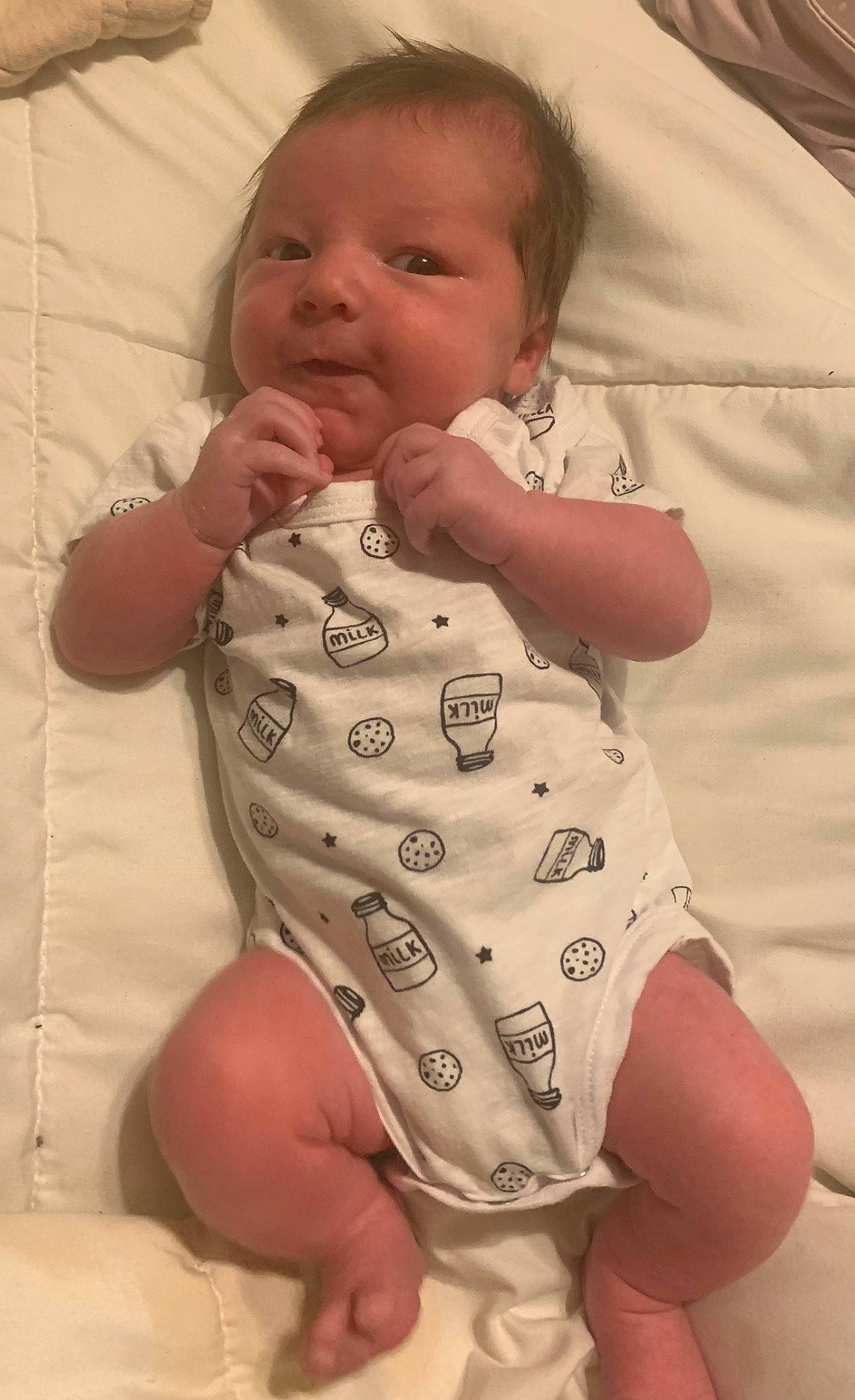 Cashton is registered to the contest to win money with this photo: baby, baby_toddler_clothing, cheek, comfort, face, finger, gesture, head, human_body, infant_bodysuit, joint, lip, mouth, neck, nose, person, pink, skin, sleeve, stomach