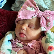 Misty joined the competition — help win amazing prizes! baby, sleeping, bow, pink, blanket, floral, cute, infant, hands, clothing, face, headwear, closeup, peaceful, soft, newborn, portrait, wrapped, cozy, indoors