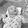 baby, infant, mirror, reflection, play_mat, onesie, stars_pattern, hand, face, gaze, curious, lying_down, child, soft_toys, indoor, monochrome, close_up, portrait, cute, newborn
