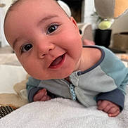 Henry joined the competition — help win amazing prizes! baby, blanket, blue, closeup, clothing, curious, cute, expression, eyes, face, gray, hand, happy, home, indoor, infant, portrait, smile, toddler, toy