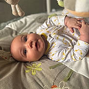 Henry joined the competition — help win amazing prizes! baby, infant, blanket, soft_toy, embroidery, bedroom, sleepwear, cute, child, portrait, hand, face, lying_down, indoors, decor, fabric, comfort, young_child, playful, resting