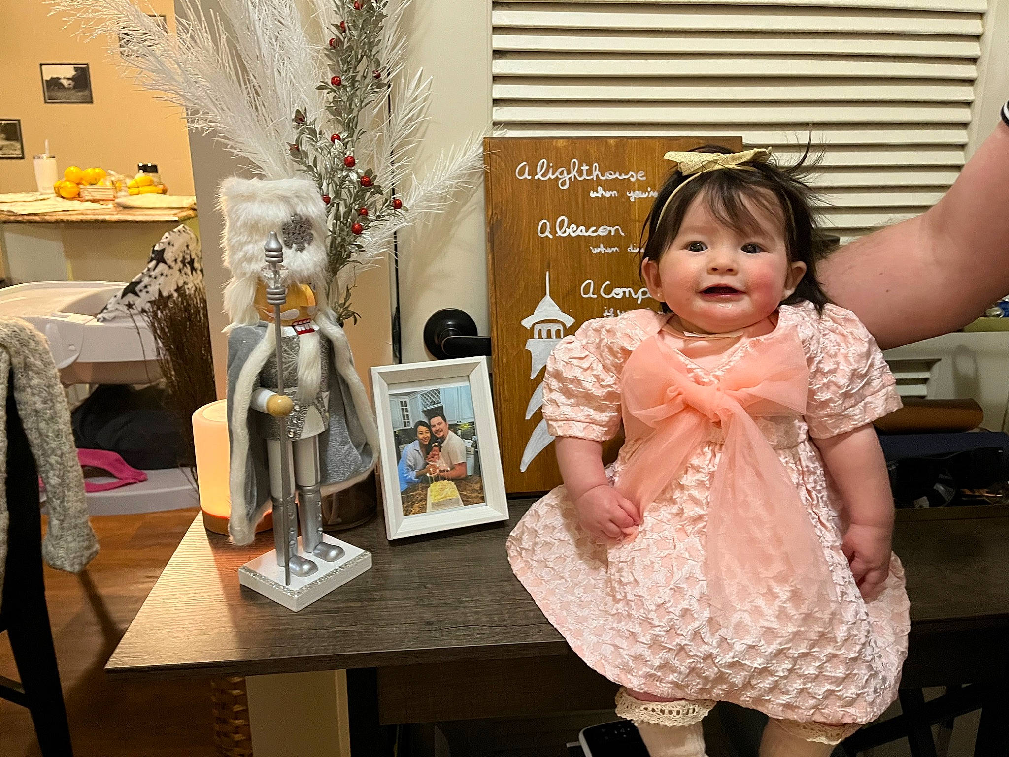 Vienna is registered to the contest to win money with this photo: baby_toddler_clothing, child, event, fashion_design, happy, jewellery, necklace, pattern, peach, person, picture_frame, room, sitting, table, toddler, vintage_clothing