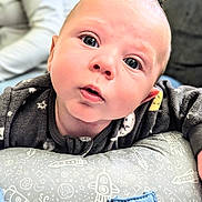 Henry joined the competition — help win amazing prizes! baby, infant, face, eyes, pajamas, pillow, space_theme, stars, hand, cute, child, resting, indoors, portrait, soft_lighting, close_up, cozy, expression, skin, young