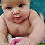 Madilynn joined the competition — help win amazing prizes! baby, infant, face, hand, blanket, towel, pink, yellow, green, purple, floral, quilting, curious, cute, skin, child, indoors, closeup, soft, expression