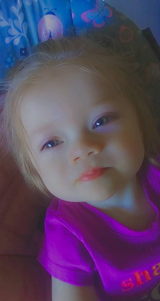 Jayleigh is registered to the contest to win money with this photo: baby, baby_toddler_clothing, cheek, chin, eyebrow, eyelash, facial_expression, fun, grass, hairstyle, happy, human, iris, lip, nose, person, pink, purple, skin, toddler