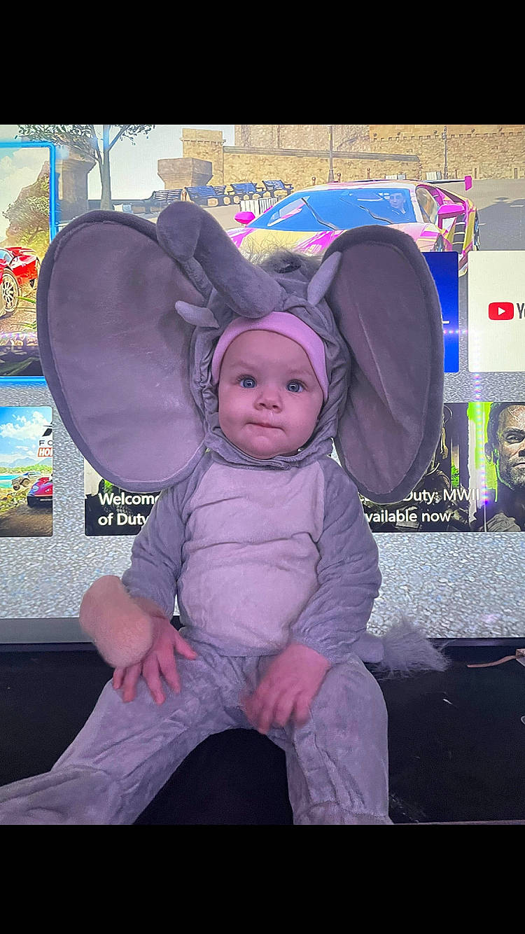 Rosalynn is registered to the contest to win money with this photo: baby, baby_toddler_clothing, child, cool, costume_hat, fashion_accessory, fictional_character, fun, happy, hat, headwear, magenta, person, pink, purple, room, sitting, sun_hat, textile, toddler