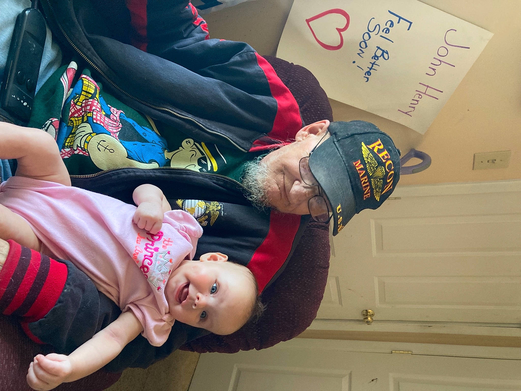 Rosalynn is registered to the contest to win money with this photo: arm, baby, baby_toddler_clothing, child, comfort, elbow, event, foot, fun, gesture, hand, happy, headwear, human_leg, lap, person, sitting, smile, thigh, toddler