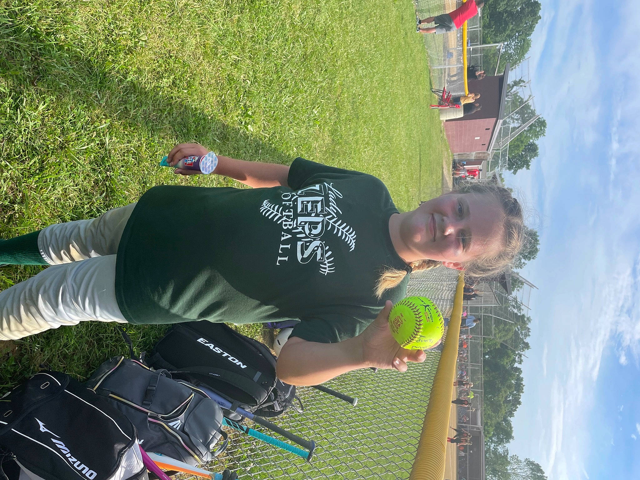 Dixie is registered to the contest to win money with this photo: black, cloud, fun, grass, green, happy, joy, knee, leaf, leisure, people_in_nature, person, photograph, recreation, shorts, sky, smile, snapshot, t_shirt, travel