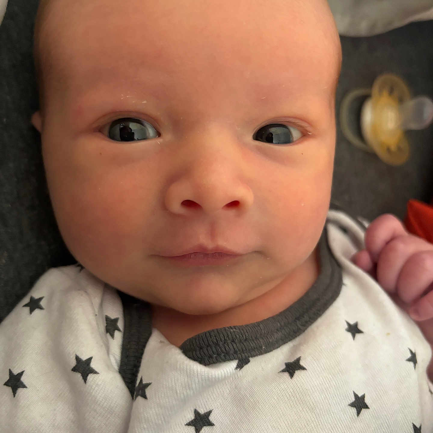 Greyson is registered to the contest to win money with this photo: applique, baby, bodypart, clothing, face, finger, hand, happy, head, hoodie, knitwear, mouth, newborn, pattern, person, photography, portrait, smile, sweater, sweatshirt