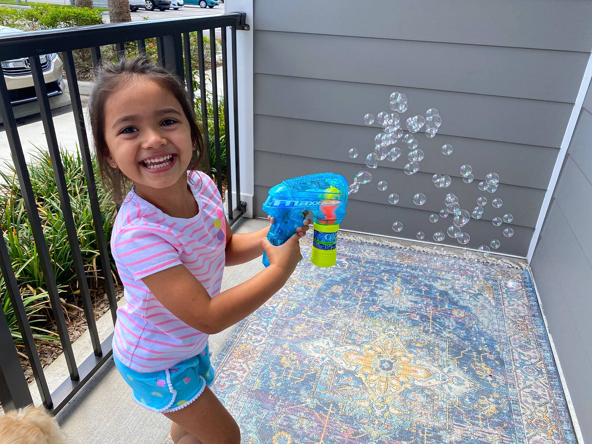 Natalia is registered to the contest to win money with this photo: child, glass, hand, joy, person, play, room, smile, summer, toddler, vacation, water, water_gun