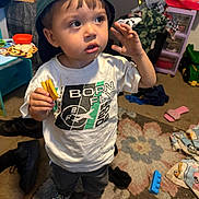 Mateo joined the competition — help win amazing prizes! toddler, child, indoor, cap, snack, shirt, curious, standing, toy, carpet, clothing, footwear, messy_room, blanket, furniture, person, expression, floor, home, casual