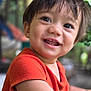 child, toddler, smiling, face, eyes, hair, orange_shirt, skin, happy, portrait, indoors, closeup, expression, cute, person, young_child, cheerful, background_blur, clothing, baby