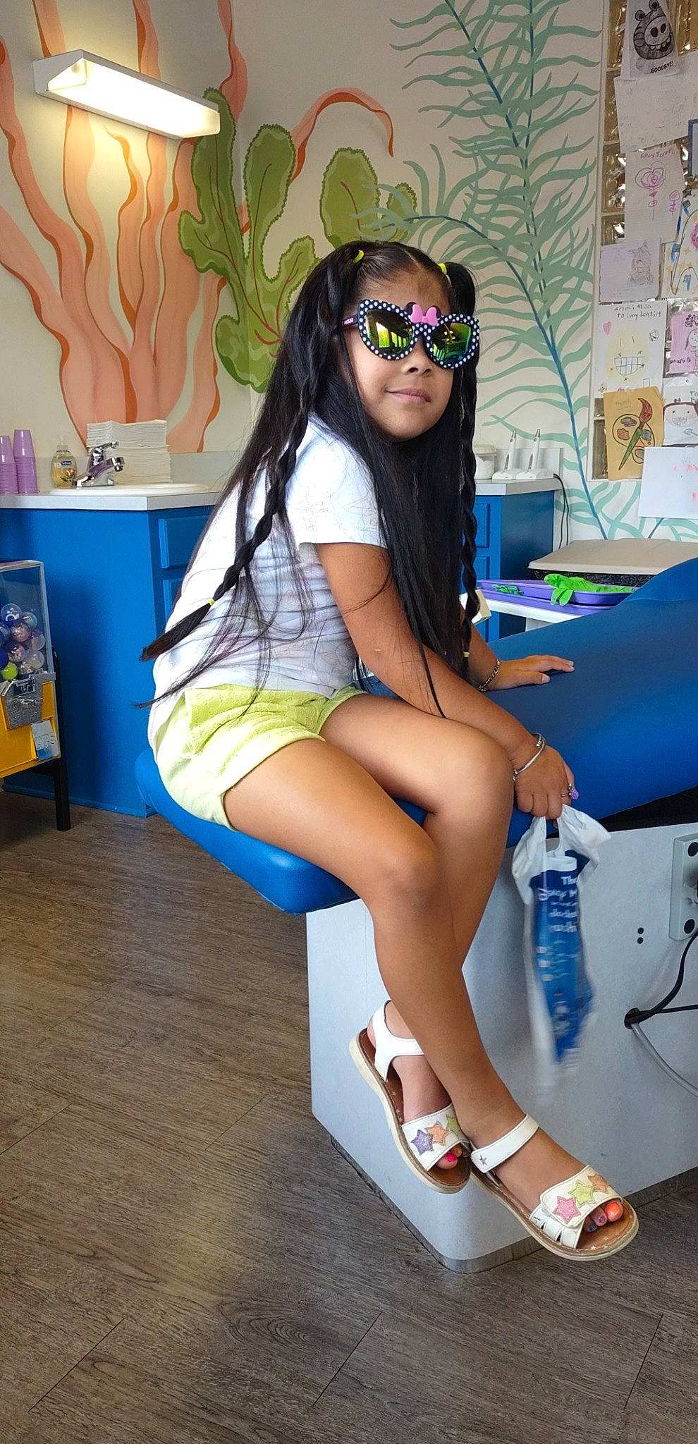 Inaya is registered to the contest to win money with this photo: beauty, black_hair, blue, electric_blue, eyewear, goggles, hairstyle, human_leg, joint, knee, leg, long_hair, person, sandal, shoe, shorts, sunglasses, thigh, trunk, vision_care