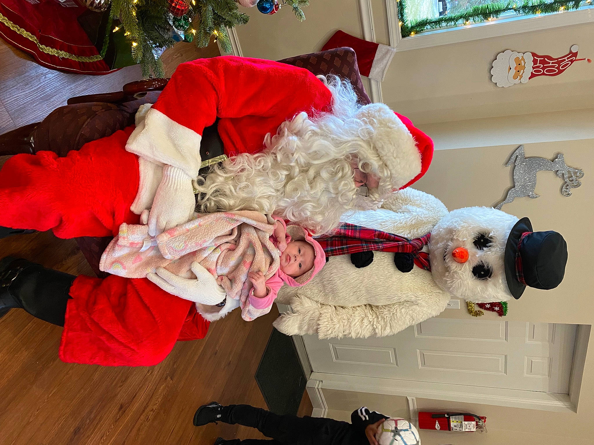 Rylee joined the competition — help win amazing prizes! carmine, christmas, christmas_eve, christmas_ornament, costume, costume_hat, event, fictional_character, fur, hat, headwear, holiday, interior_design, lap, person, plush, red, room, santa_claus, stuffed_toy