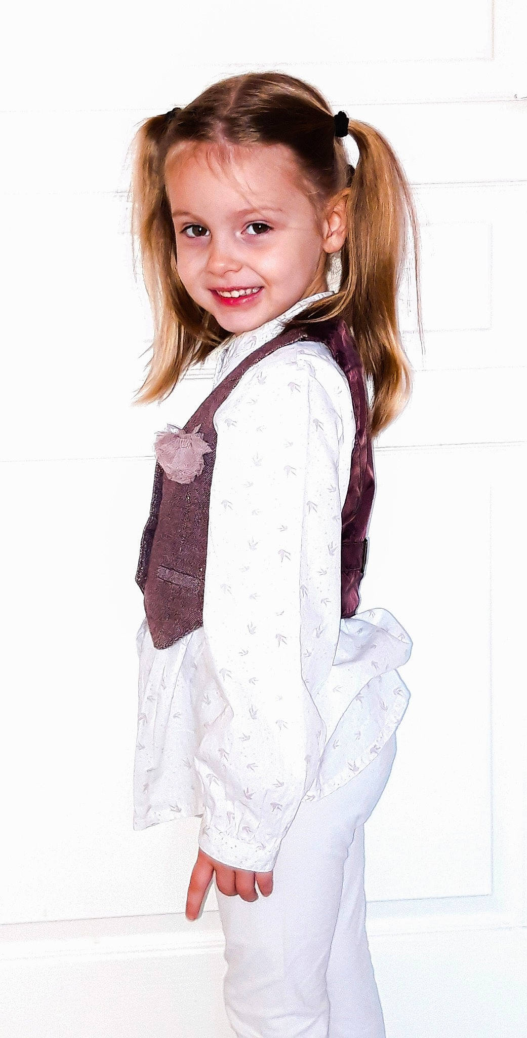 Maelyss participe au concours pour gagner de l'argent avec cette photo : brown_hair, child, child_model, clothing, dress, formal_wear, hair, hairstyle, jacket, joy, long_hair, neck, outerwear, person, pink, sleeve, smile, toddler, top, white