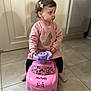 Mya participe au concours pour gagner de l'argent avec cette photo : toddler, child, indoor, toy, pink, minnie_mouse, ride_on_toy, floor, tile, girl, clothing, hair_clip, sitting, looking_away, cute, play, young_child, person, footwear, casual