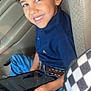 Santiago joined the competition — help win amazing prizes! child, boy, curly_hair, smile, tablet, car_seat, blue_shirt, jeans, belt, indoor, happy, casual, technology, portrait, seatbelt, window, car_interior, young, person, sitting
