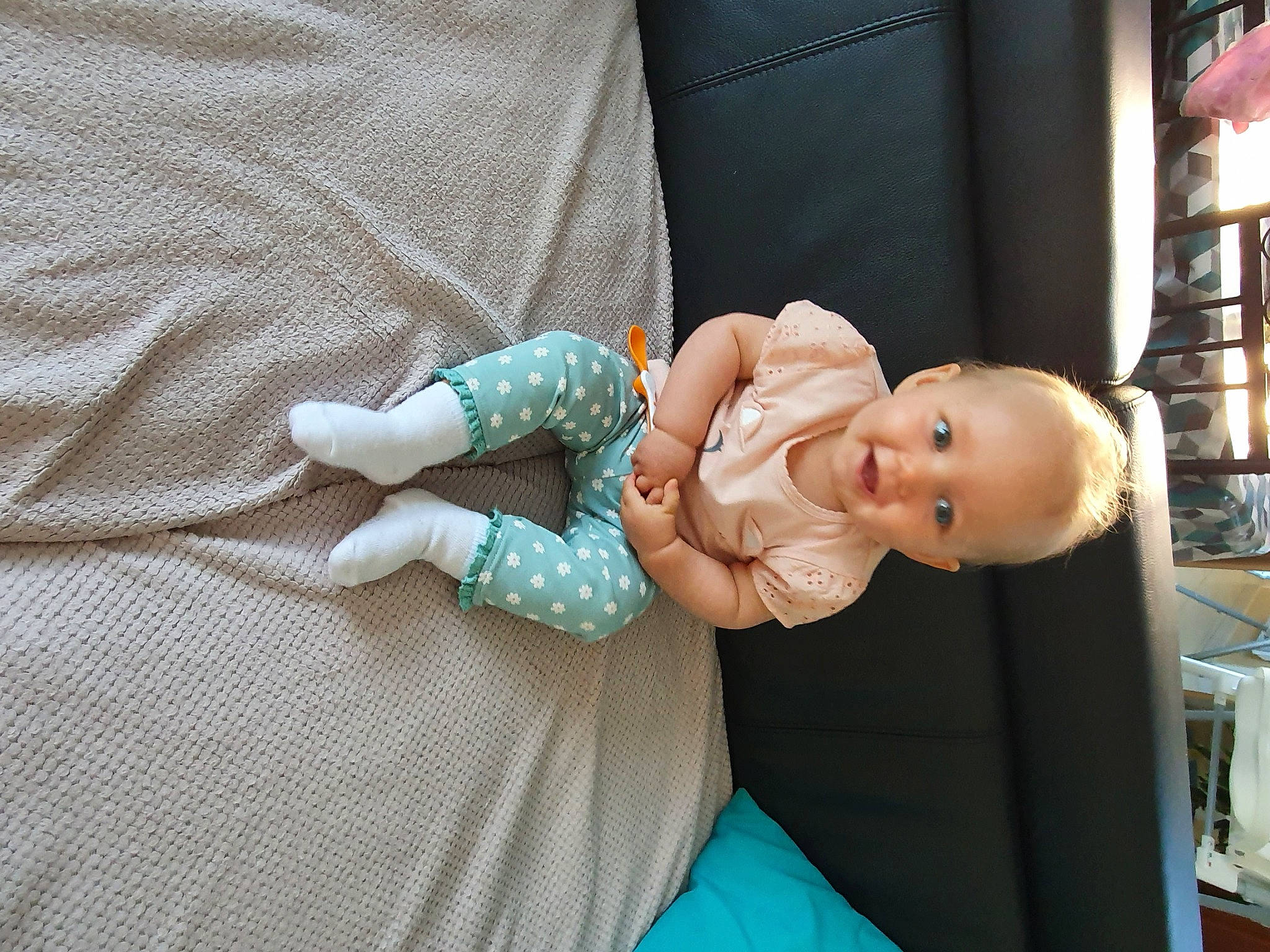 Eleanore participe au concours pour gagner de l'argent avec cette photo : arm, baby, baby_products, baby_toddler_clothing, child, comfort, doll, dress, fashion_accessory, finger, hand, happy, human_body, pattern, person, room, sitting, smile, textile, toddler