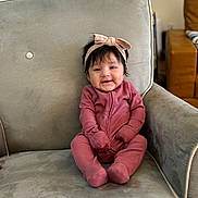 Layana joined the competition — help win amazing prizes! armchair, baby, child, cozy, cute, face, furniture, hair, happy, headband, home, indoor, infant, person, pink_onesie, portrait, seated, smile, soft_lighting, young_child
