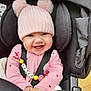 accessory, baby, baby_clothing, car_seat, child, close_up, cute, happy, heart_pattern, indoors, infant, knitwear, pacifier, person, pink, pink_hat, pom_poms, seatbelt, smiling, toy