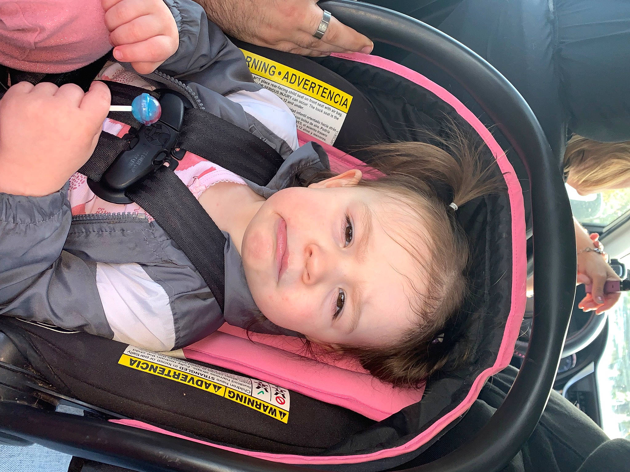 Hanna is registered to the contest to win money with this photo: auto_part, baby, baby_carriage, baby_in_car_seat, baby_products, car_seat, child, comfort, facial_expression, fun, motor_vehicle, person, personal_protective_equipment, steering_wheel, thumb, toddler