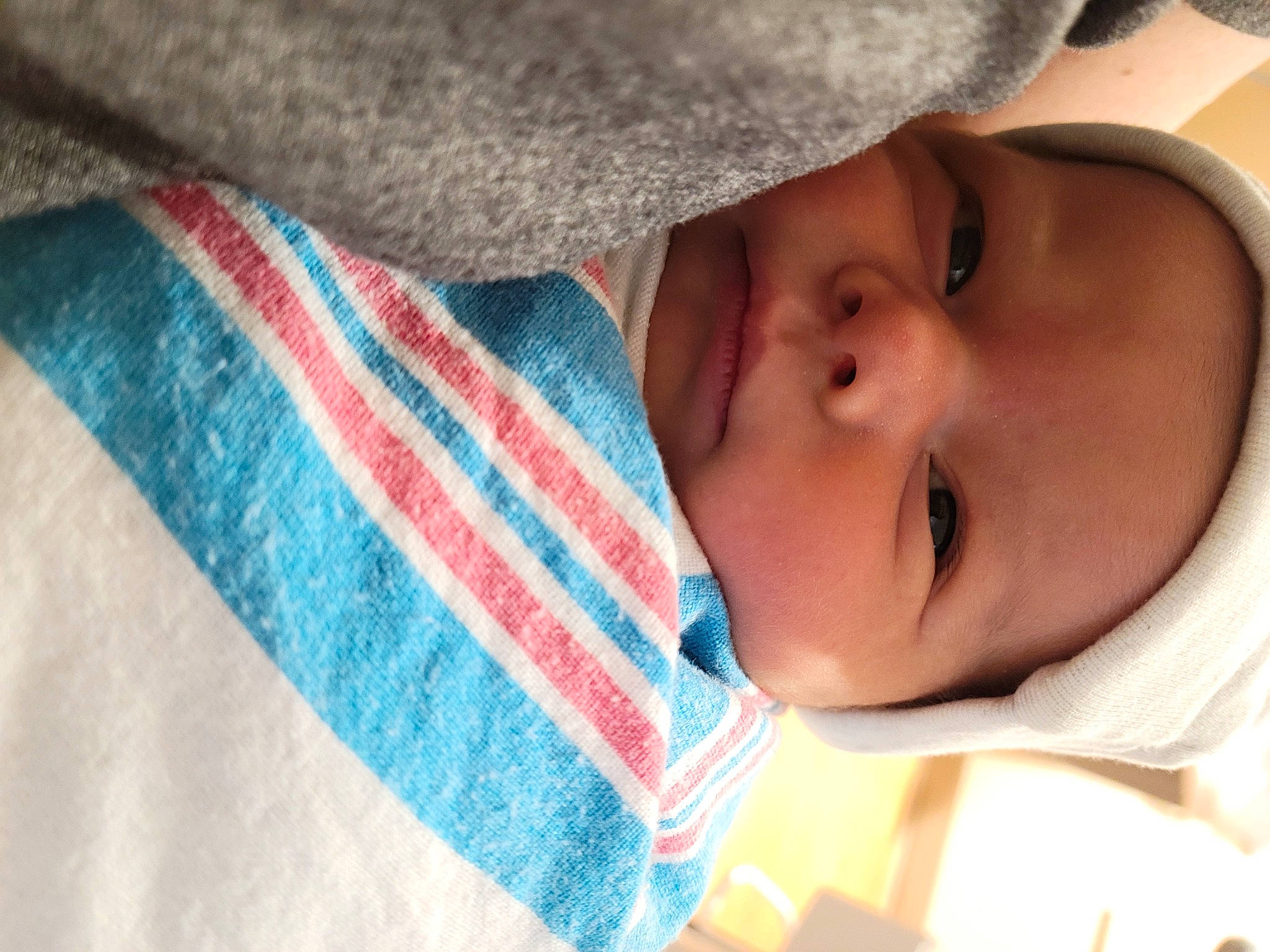 Ryan is registered to the contest to win money with this photo: arm, baby, baby_toddler_clothing, cheek, child, close_up, clothing, comfort, eye, finger, hand, iris, linens, lip, nose, person, pink, skin, sleeve, textile