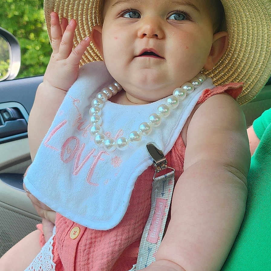 Maggie joined the competition — help win amazing prizes! accessories, baby, bodypart, bonnet, cap, clothing, dress, face, finger, hand, hat, head, homedecor, jewelry, necklace, person, photography, portrait, sitting, sunhat