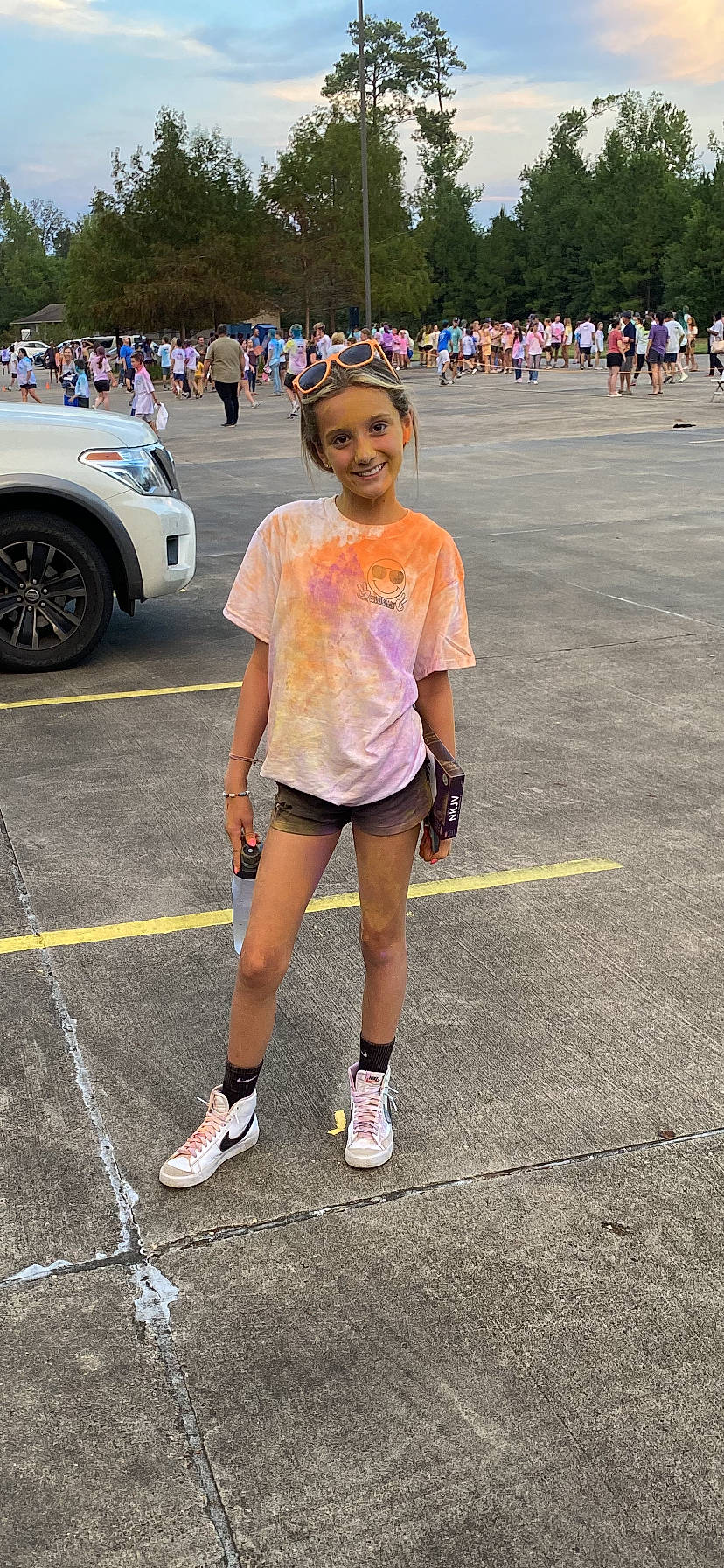 Addison is registered to the contest to win money with this photo: asphalt, athlete, car, clothing, fun, hat, human_leg, joy, leisure, motor_vehicle, person, pink, road, running, shorts, sneakers, t_shirt, thigh, tire, vehicle