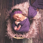 Jahsani joined the competition — help win amazing prizes! baby, newborn, sleeping, purple_cloth, headband, fluffy_blanket, pink, wooden_floor, wrapped, closeup, peaceful, cute, infant, portrait, cozy, soft_texture, smiling, hands, feet, indoor